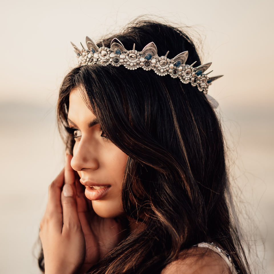 Beautiful Indian girl with a silver crown staring into the sunset