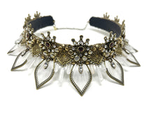 Load image into Gallery viewer, Close up of the 5mm ruby red garnets inlaid in the antique gold filigree and surrounded by clear rhinestones and white pearls.  Antique gold petals are hand threaded with ivory thread to create a delicate sunflower silhouette for the crown.  In between each petal are three cascading quartz crystal points.
