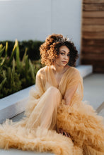 Load image into Gallery viewer, Woman posing in orange ruffled dress at golden hour as the sunlight reflects off her dark curls and the antique gold crown with crystals reflects the light