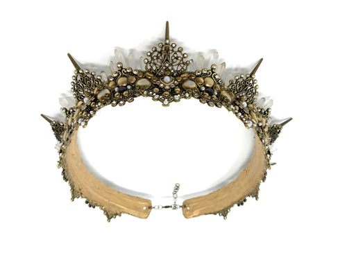 Amoura is a handcrafted antique gold crown built on a leather adjustable base with 5 tiers of cascading natural quartz, 6mm ruby red garnet rounds, freshwater natural pearls and Swarovski crystals. This headpiece has 1 inch tall spikes and antique gold filigree with a breathtakingly delicate silhouette.