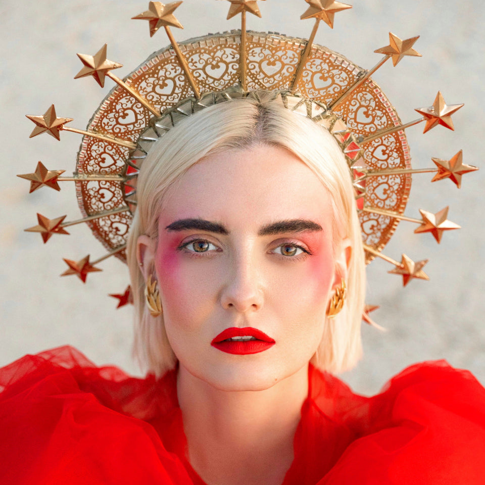 Beautiful blonde in a red dress with a golden star halo crown on her head