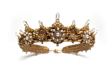 Load image into Gallery viewer, Named after the Queen of all Muses, this gold crown has a ring of the clearest quartz crystals peaking out from behind the most intricate gold filigree. Natural pearls and sparkling rhinestones glitter in perfect harmony.  In ancient Greek mythology, Caliope is the Muse who presides over eloquence and epic poetry. Wear her on your head to inspire an epic love poem of your own.
