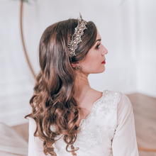 Load image into Gallery viewer, Brown haired bride posing from the side wearing the Amoura crown
